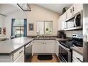Updated kitchen featuring white cabinets and gray countertops at 2201 N Comanche Dr # 1075, Chandler, AZ 85224
