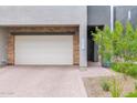 Attached garage with brick accents and paved driveway at 25330 N 19Th Dr, Phoenix, AZ 85085