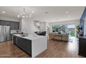 Open concept kitchen with island, stainless steel appliances, and hardwood floors at 25330 N 19Th Dr, Phoenix, AZ 85085