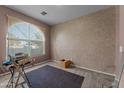Spacious bedroom with an arched window and carpet flooring at 31637 W Grant St, Buckeye, AZ 85326