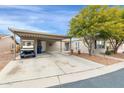 House exterior with carport, landscaping, and golf cart at 3301 S Goldfield Rd # 1015, Apache Junction, AZ 85119