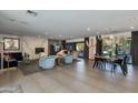 Open concept living room with fireplace, dining area and modern decor at 3601 N 55Th Pl, Phoenix, AZ 85018