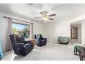 Living room with tiled floors, two recliners, and a ceiling fan at 3801 W Barnes Ln, Phoenix, AZ 85051