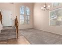 Spacious living room with high ceilings and large windows at 41405 W Cielo Ln, Maricopa, AZ 85138
