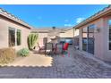 Backyard patio with a built-in fireplace and grill at 42413 W Abbey Rd, Maricopa, AZ 85138