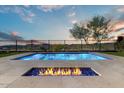 Modern rectangular pool and fire pit with mountain views at 44630 N Sonoran Arroyo Ln, New River, AZ 85087