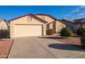 Front view of a beige house with a two-car garage and small front yard at 4872 E Sandwick Dr, San Tan Valley, AZ 85140