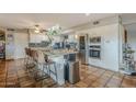 Modern kitchen featuring white cabinets, granite countertops, and a large island at 5301 E Mitchell Dr, Phoenix, AZ 85018