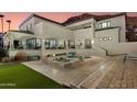 An outdoor area boasts a spa and a pool against the backdrop of a two-story home with multiple balconies at 5427 E Wonderview Rd, Phoenix, AZ 85018