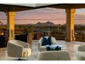 Balcony seating showcasing city views at sunset, complemented by stylish decor and neutral toned furniture at 5427 E Wonderview Rd, Phoenix, AZ 85018