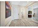 Bright and spacious entryway with wood-look tile floors at 5566 N 206Th Gln, Buckeye, AZ 85396