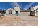 Single-story home boasts a covered entryway, two-car garage, and low-maintenance landscaping at 7276 E Purple Prairie Dr, San Tan Valley, AZ 85143