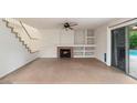 Living room with a fireplace and built-in shelving at 7447 E Christmas Cholla Dr, Scottsdale, AZ 85255