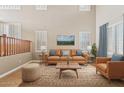 Living room with a leather couch and wood coffee table at 7603 W Encinas Ln, Phoenix, AZ 85043