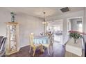 Charming dining room with a round table, four chairs, and built-in hutch at 9710 W Rodeo Ct, Sun City, AZ 85373