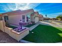 Well-kept home features a manicured lawn, flower bed and an attached two-car garage at 1041 N 91St Pl, Mesa, AZ 85207