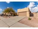 House exterior with a tan stucco finish and a two car garage at 10454 E Peralta Canyon Dr, Gold Canyon, AZ 85118