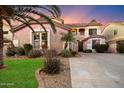 Two-story house with a landscaped front yard and a gated entrance at 10730 E Medina Ave, Mesa, AZ 85209