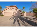 Two-story house with a two-car garage and gated entryway at 10921 W Bermuda Dr, Avondale, AZ 85392