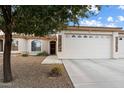 Inviting exterior with a two-car garage and well-manicured landscaping at 10960 E Monte Ave # 196, Mesa, AZ 85209