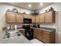 Modern kitchen featuring dark wood cabinets and stainless steel appliances at 10960 E Monte Ave # 196, Mesa, AZ 85209