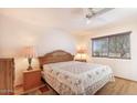 Cozy bedroom with a ceiling fan, natural light, and a comfortable bed at 11008 W Cherry Hills W Dr, Sun City, AZ 85351