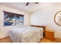 Comfortable bedroom featuring a neutral color scheme and a large window at 11008 W Cherry Hills W Dr, Sun City, AZ 85351