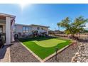 Relaxing backyard with putting green and gravel landscaping at 12406 W Allegro Dr, Sun City West, AZ 85375