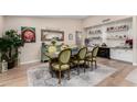 Bright dining room featuring a rustic wooden table and green chairs at 12406 W Allegro Dr, Sun City West, AZ 85375