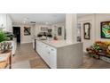 Modern kitchen island with white cabinets and quartz countertops at 12406 W Allegro Dr, Sun City West, AZ 85375