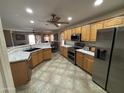 Spacious kitchen featuring stainless steel appliances and light wood cabinets at 1534 E Alba Dr, Casa Grande, AZ 85122