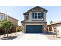 Two-story house with stone accents and a two-car garage at 18147 W Lundberg St, Surprise, AZ 85388