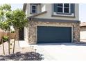 Two-story house with stone accents and a two-car garage at 18147 W Lundberg St, Surprise, AZ 85388