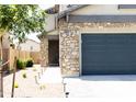 Two-story house with stone accents and a two-car garage at 18147 W Lundberg St, Surprise, AZ 85388