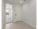 Bright foyer with neutral tile flooring and a view into a bedroom at 18225 W Hess St, Goodyear, AZ 85338
