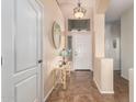 Bright entryway with tile flooring, a console table, and mirror at 18258 W Spencer Dr, Surprise, AZ 85374