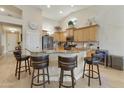 Modern kitchen with granite countertops, stainless steel appliances, and breakfast bar at 1893 E San Carlos Pl, Chandler, AZ 85249