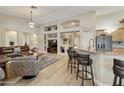 Spacious living room with hardwood floors, leather furniture, and built-in shelving at 1893 E San Carlos Pl, Chandler, AZ 85249