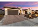 Stunning curb appeal with desert landscaping and a gorgeous sunset backdrop at 19027 N 269Th Dr, Buckeye, AZ 85396