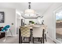 Open-concept dining area with stylish furnishings and decor adjacent to the kitchen at 222 S 223Rd Dr, Buckeye, AZ 85326