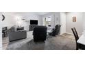 Cozy living room featuring a gray sofa, two black recliner chairs, and a wall-mounted TV at 2242 Leisure World --, Mesa, AZ 85206