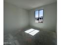 Well-lit bedroom showcasing a large window and fresh white walls, awaiting personalization at 22844 E Lords Way, Queen Creek, AZ 85142