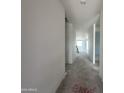 Bright hallway featuring white walls and ceilings, leading to other parts of the home at 22844 E Lords Way, Queen Creek, AZ 85142