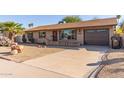 Front view of a single story home with a driveway at 2407 W Laurel Ln, Phoenix, AZ 85029