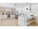 Modern white kitchen featuring stainless steel appliances and a large island at 2816 E Cholla St, Phoenix, AZ 85028