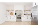 Clean and contemporary kitchen with white cabinets and a patterned tile accent at 2816 E Cholla St, Phoenix, AZ 85028