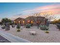 This single-story home features a welcoming front yard with drought-tolerant landscaping at 28370 N 113Th Way, Scottsdale, AZ 85262