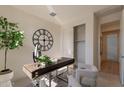 Bright home office features a large clock and built-in closet at 3238 W Garnet St, San Tan Valley, AZ 85144