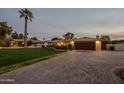 Inviting home with a brick driveway, lush landscaping, and a two-car garage at 331 E Tuckey Ln, Phoenix, AZ 85012