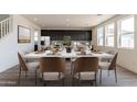 Modern dining room with a large table and brown chairs at 35775 N Zinc Dr, San Tan Valley, AZ 85144